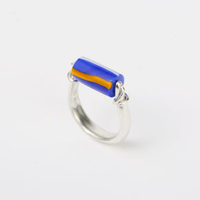 sterling silver and glass kinetic ring featuring deep blue bead with yellow stripes