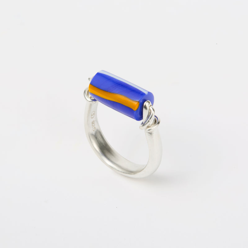 sterling silver and glass kinetic ring featuring deep blue bead with yellow stripes